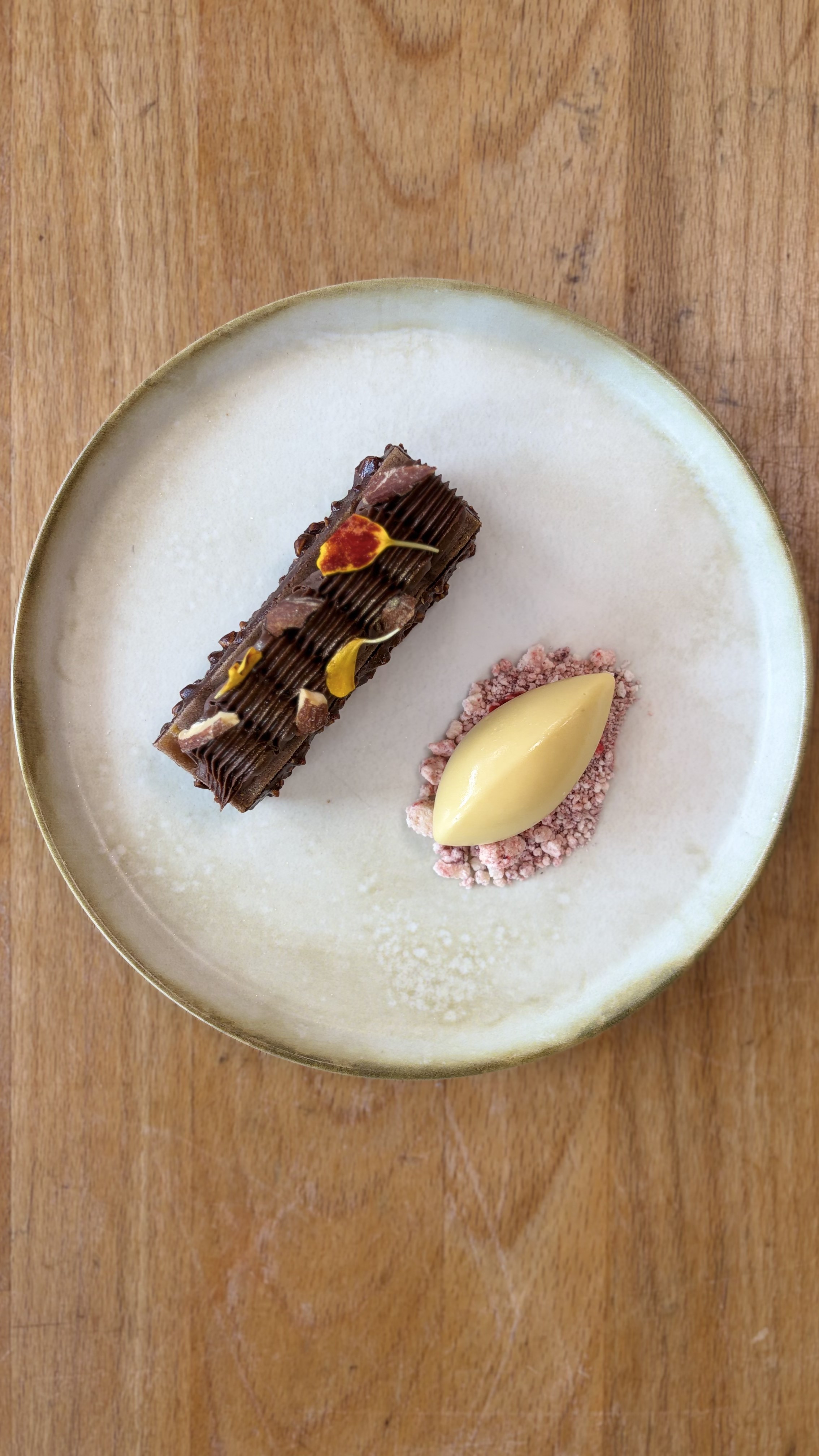Chocolate dessert with strawberry crumble and vanilla ice cream