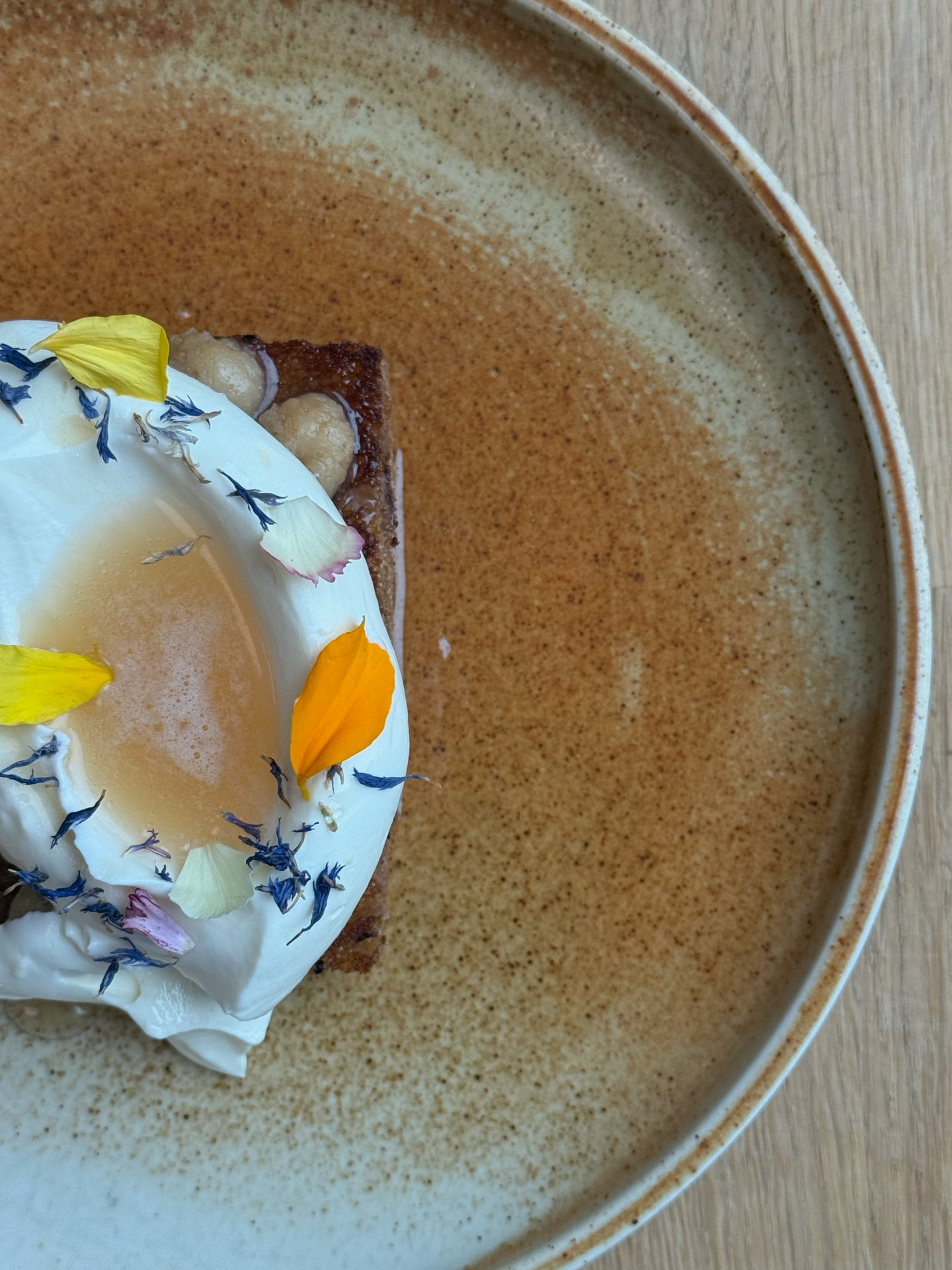 Slow egg, brioche and edible flowers