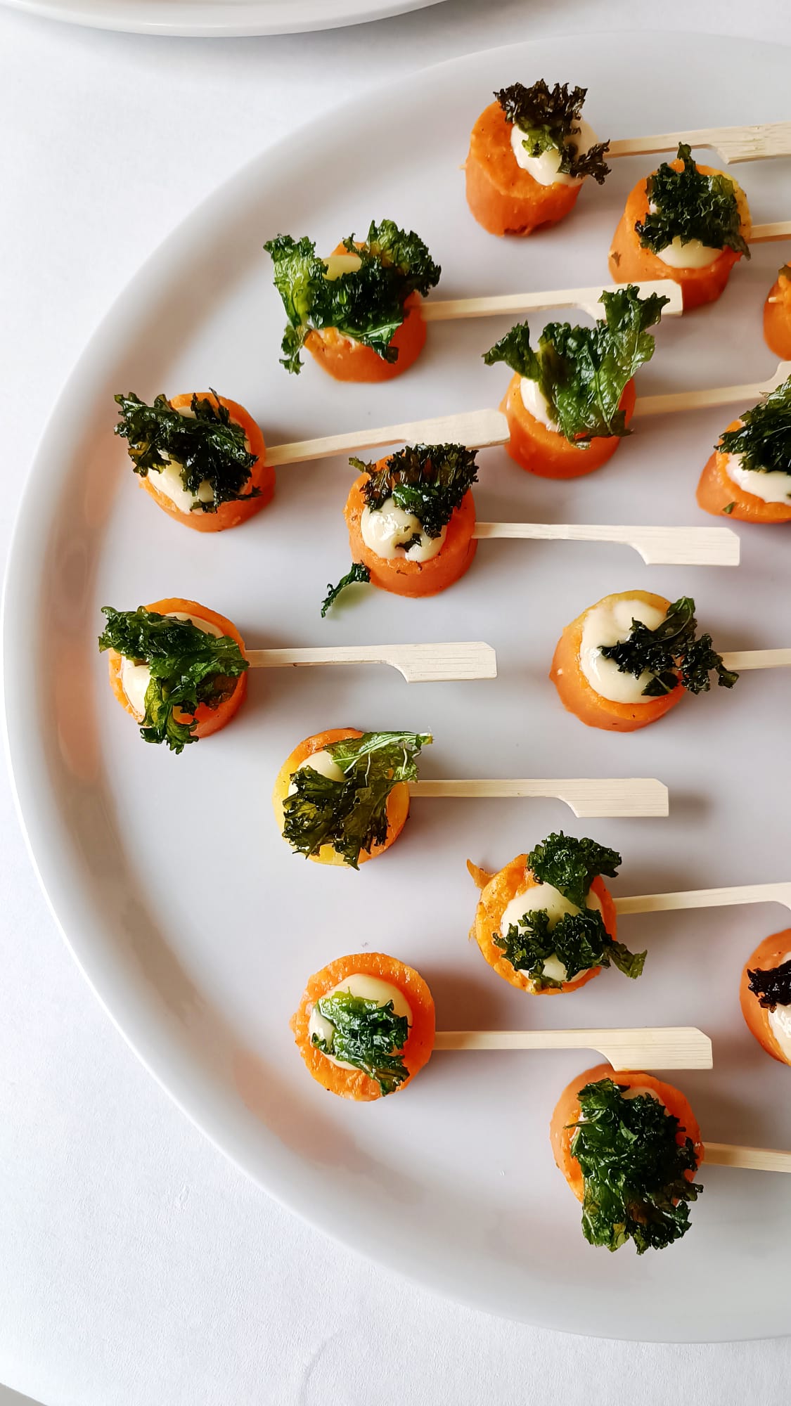 Carrot canapés with saffron cream and kale